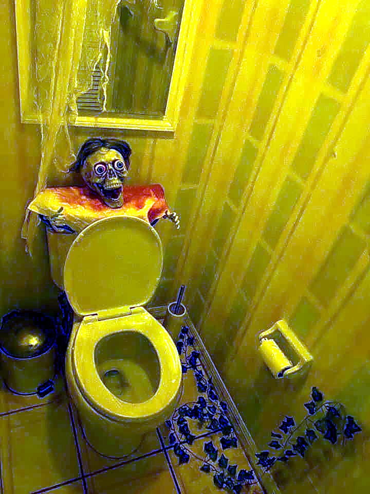 A grotesque skeleton prop waiting behind a toilet at The Haunted Tavern in 2019
