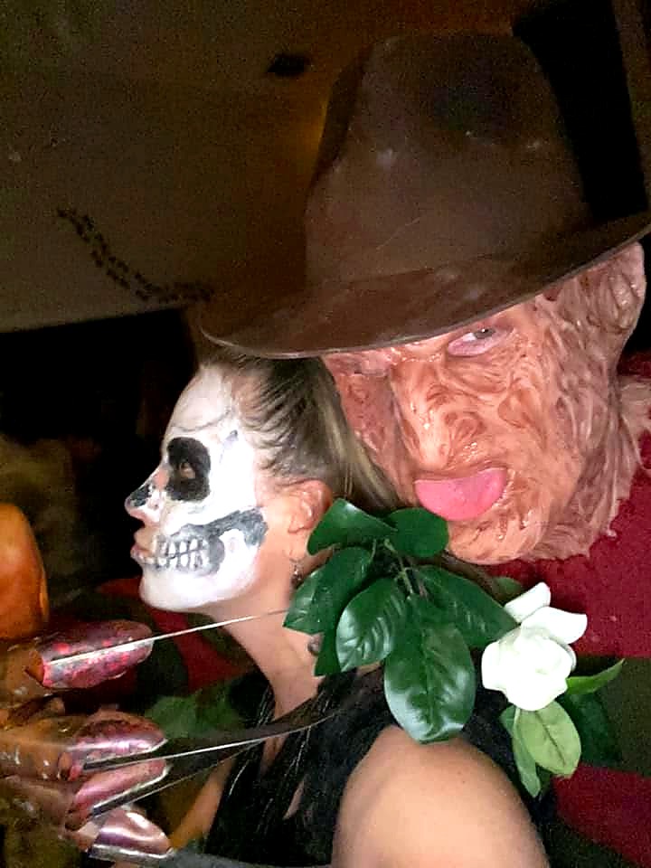 A Freddy Krueger costume posing beside a skeletal guest at The Haunted Tavern in 2019