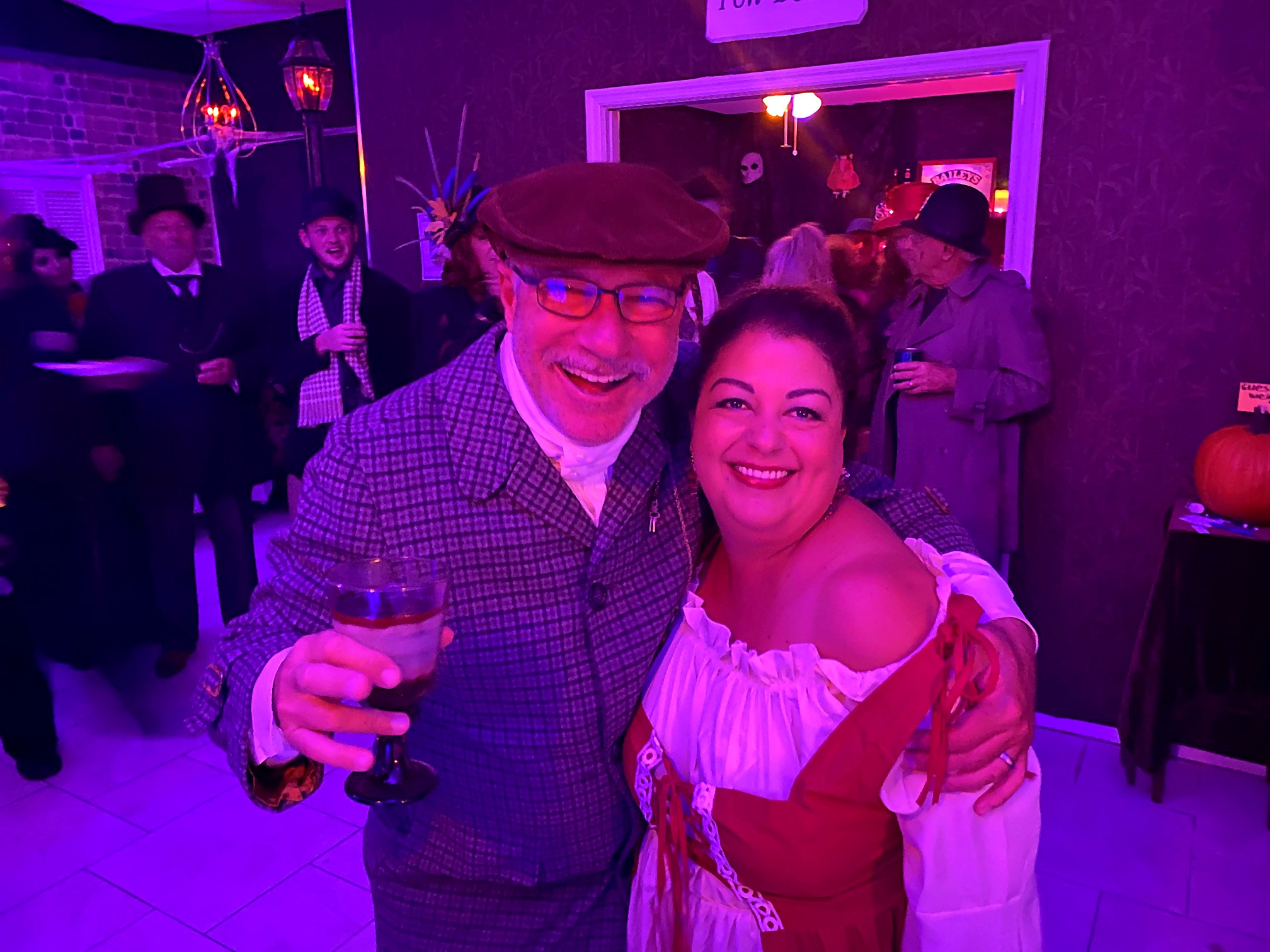 Two smiling guests in 2021 themed costumes posing together