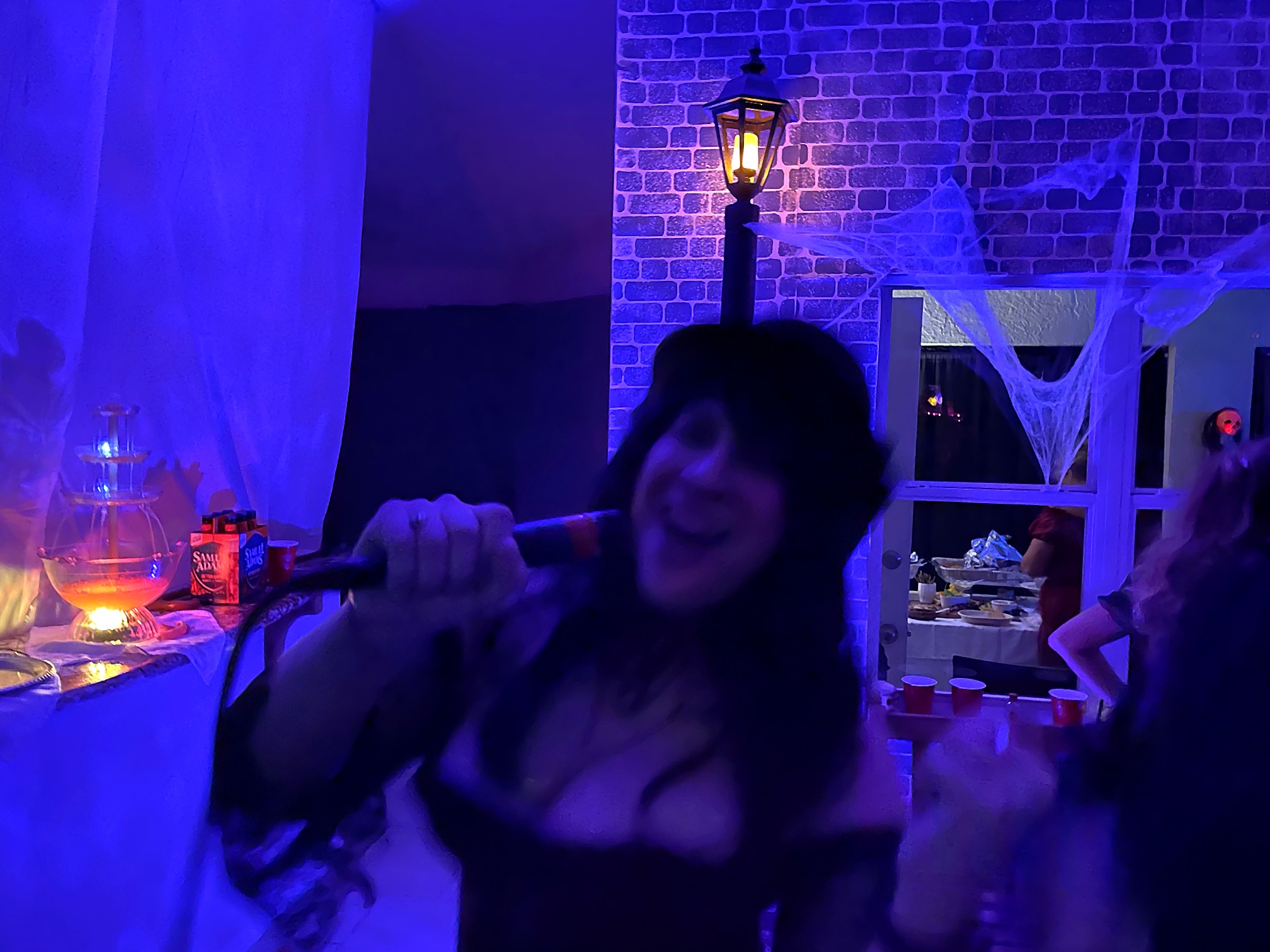 A party guest singing during the 2021 Jack the Ripper themed party