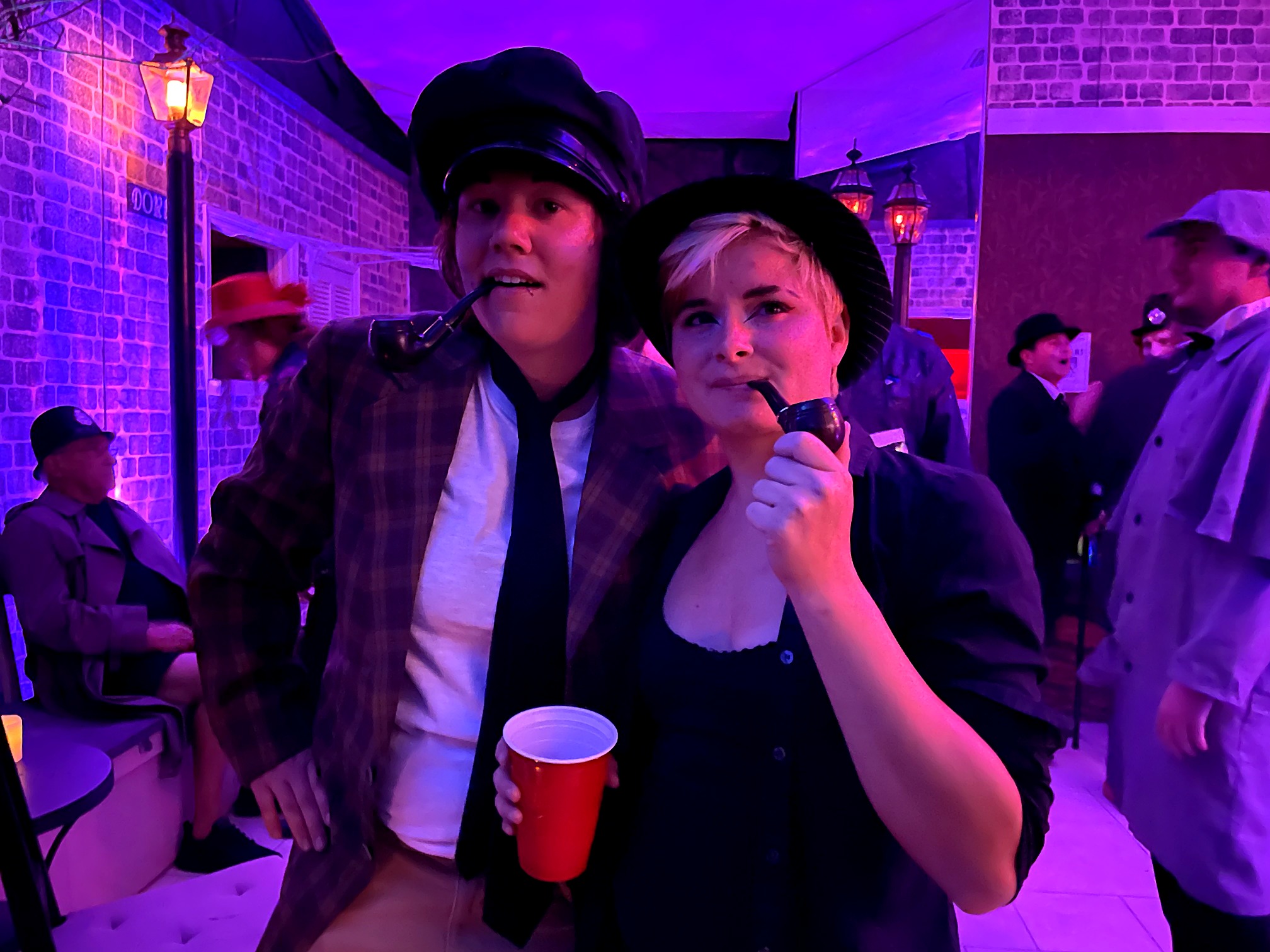 Two guests with costume pipes at the 2021 themed party