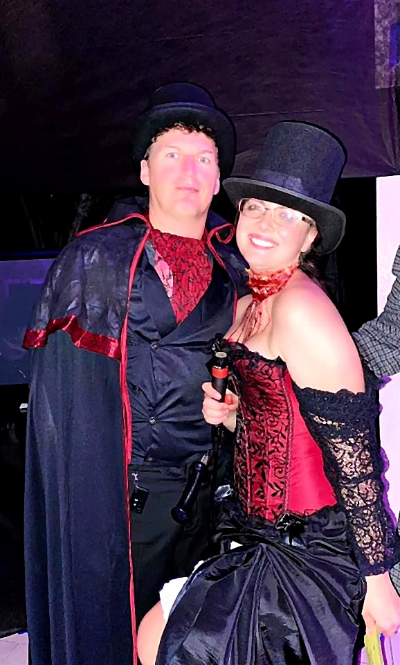 A couple in dark Victorian style costumes at the 2021 party