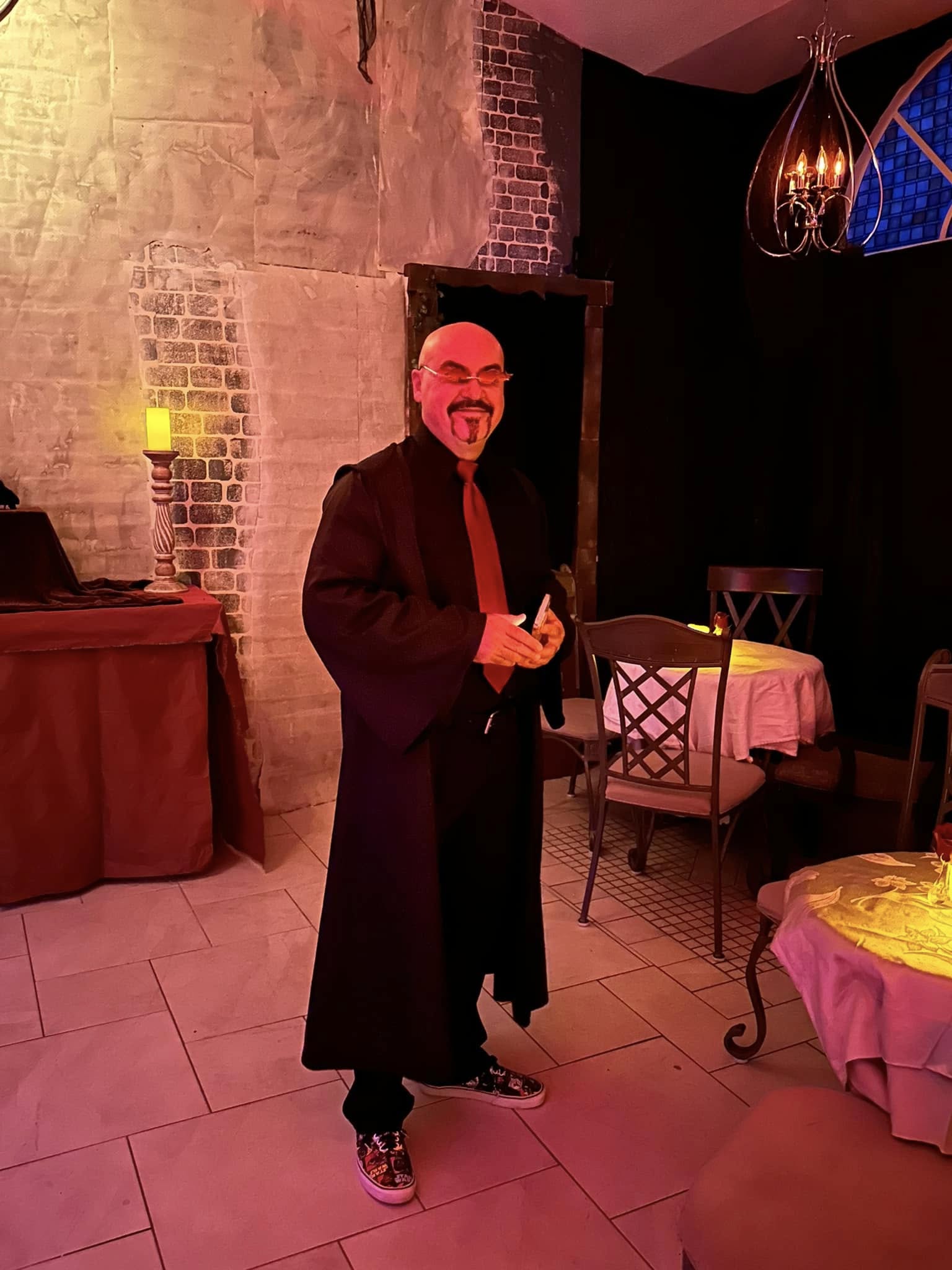 A sharply dressed party host in black and red attire at The Dublin Hellfire Club themed party