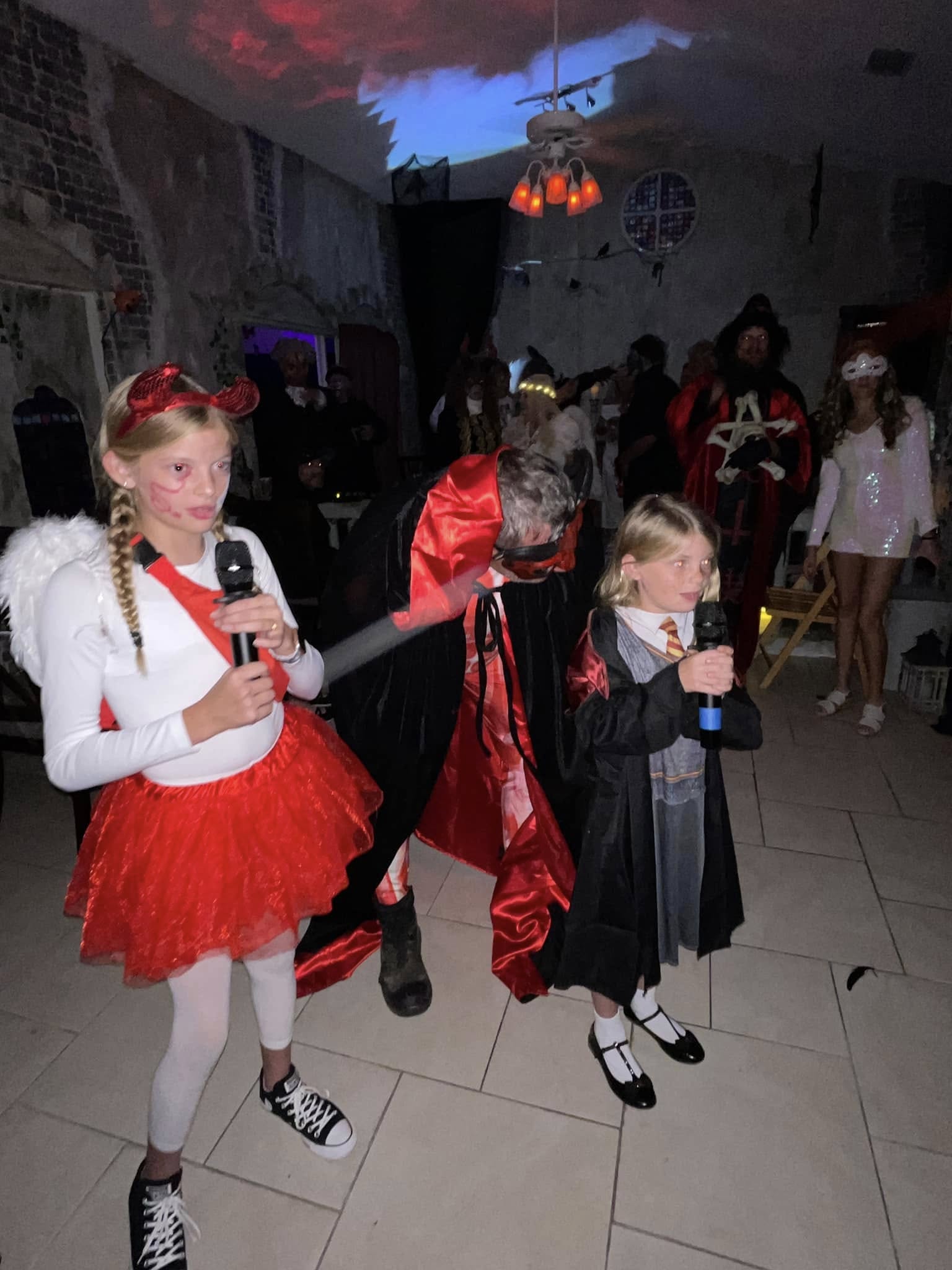 Children and guests performing with microphones during the 2023 party