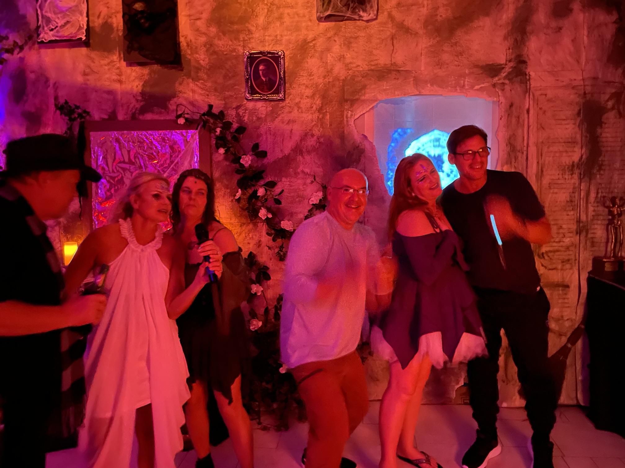 A lively group of guests performing together in front of the portal at the 2024 party