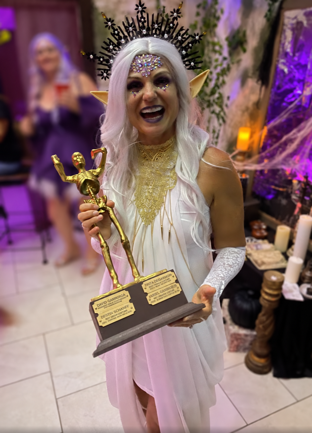 Kim M. as Sylph, The Air Spirit holding The Skelly after winning in 2024